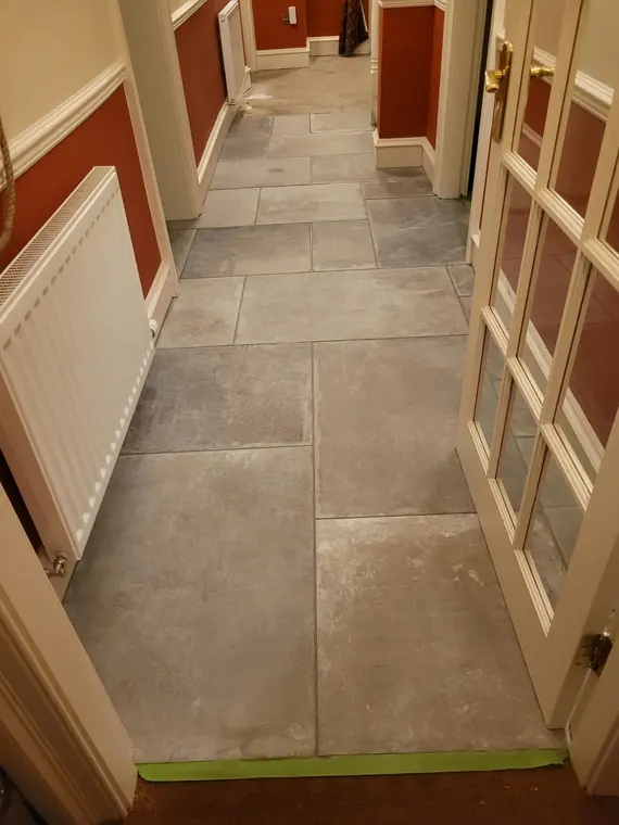 The finished hallway from the front door: one continuous floor running through to the back of the house.
