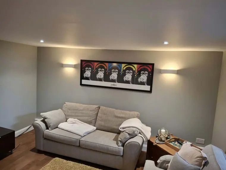 A grey feature wall with up-and-down wall lights, finished.