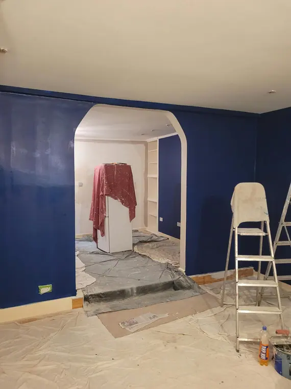 Deep navy going on, with the floor and furniture sheeted.